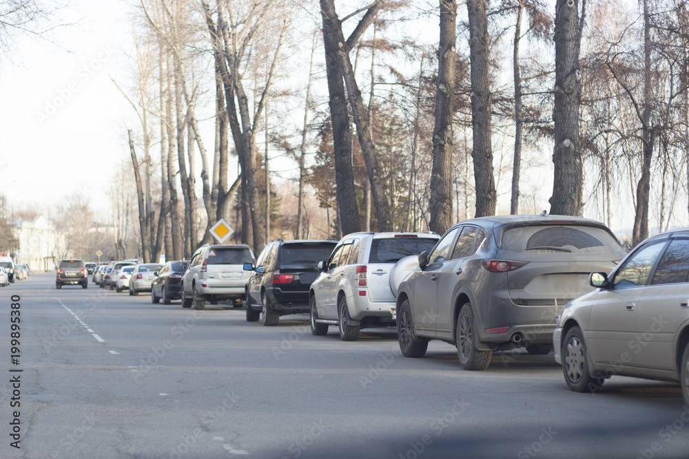 Parked cars are at the edge of the road. Parked cars are at the edge of the road.