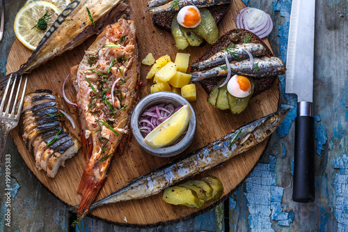 Fish plate with sturgeon, trout, perch, mackerel. Assorted fish on a plate photo