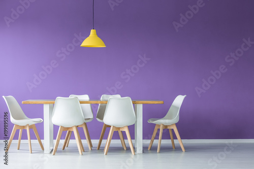 Chairs, table against purple wall