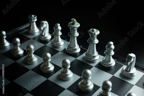 gold and silver chess on board close up image abstract Background.