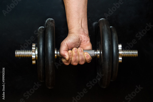 Hand holds a dumbbell