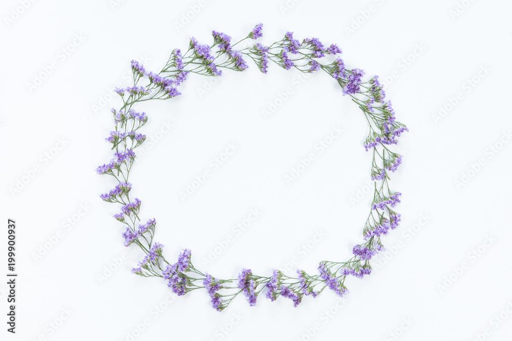 Flower wreath frame made of different flowers and leaves, flat lay, top view. Holiday background