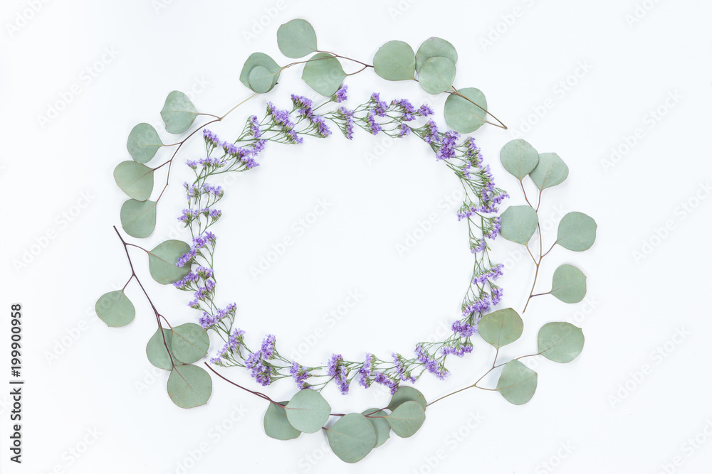 Flower wreath frame made of different flowers and leaves, flat lay, top view. Holiday background Flower wreath frame made of different flowers and leaves, flat lay, top view. Holiday background