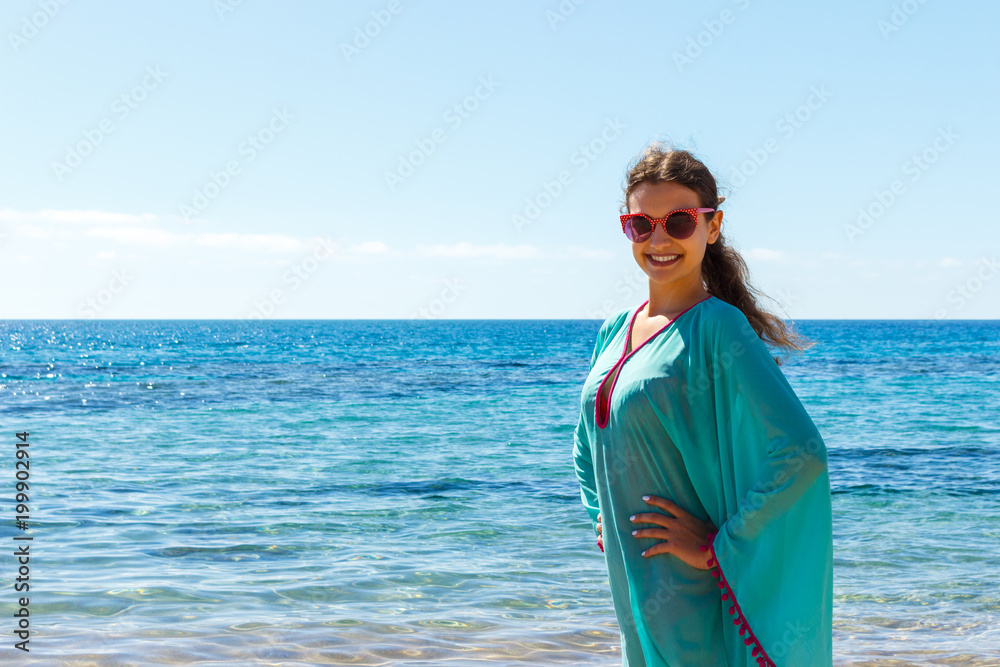 woman in white clothing refreshing at the beach on a sunny day woman in white clothing refreshing at the beach on a sunny day