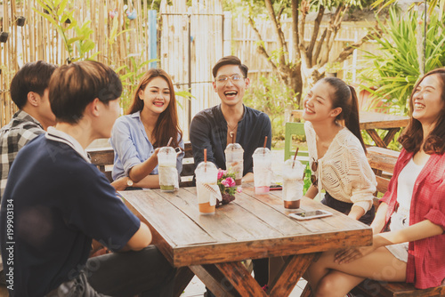 Photography Group of friends hang out in cafe play guitar and sing also use smartphone play