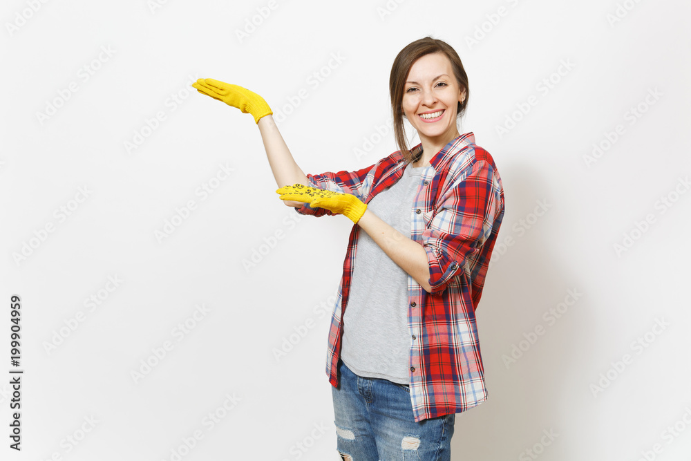 Young smiling beautiful woman in casual clothes, building yellow gloves pointing hands aside on copy space isolated on white background. Accessories for renovation apartment room. Repair home concept.
