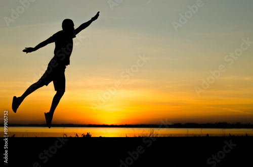 Men silhouette jumping happily.
