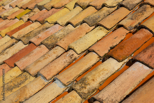 Fragment of an old tiled roof close up