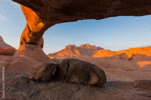Stone arch in desert photo