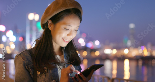Photography Woman use of mobile phone at night