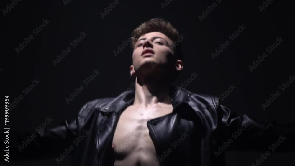 A ballet dancer in a leather jacket shows the movements of a ballet A ballet dancer in a leather jacket shows the movements of a ballet