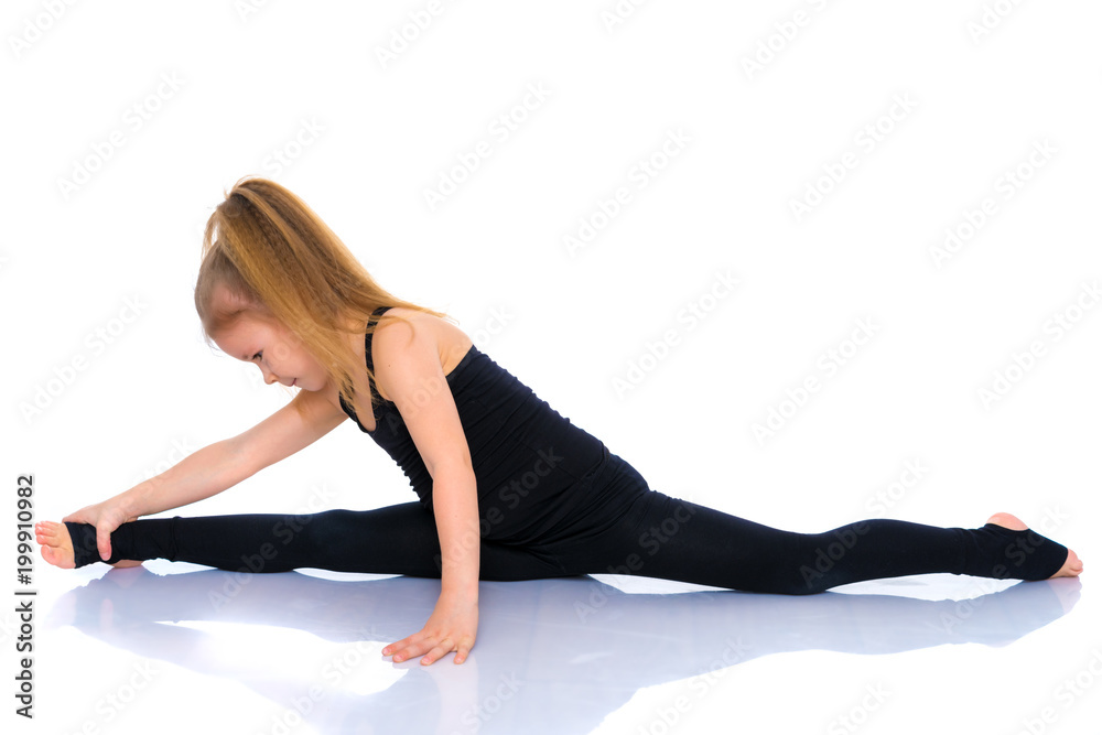 Girl gymnast perform the twine exercise. Girl gymnast perform the twine exercise.