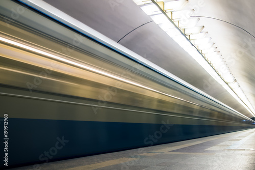 Subway train in motion arriving at station