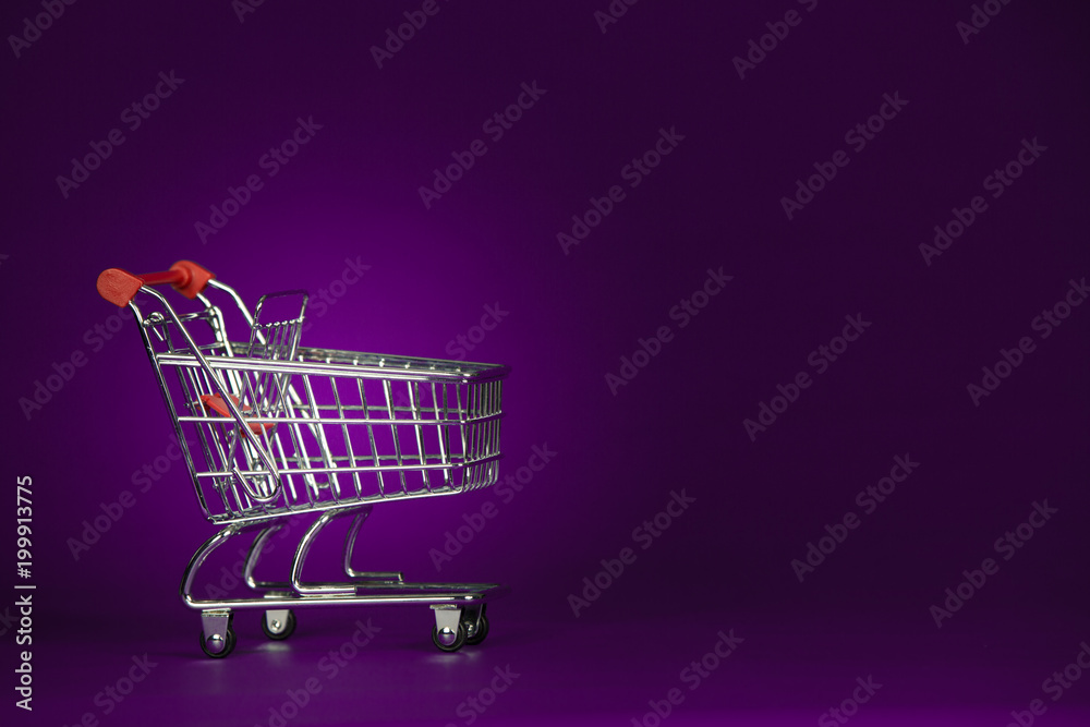 Shopping Trolly Cart on a Dark Purple Background Shopping Trolly Cart on a Dark Purple Background