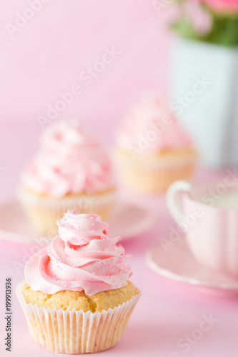Pink pastel vertical banner with decorated cupcakes, cup of coffe with milk and bouquet of pink roses.