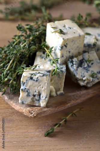 Blue cheese on a wooden table .