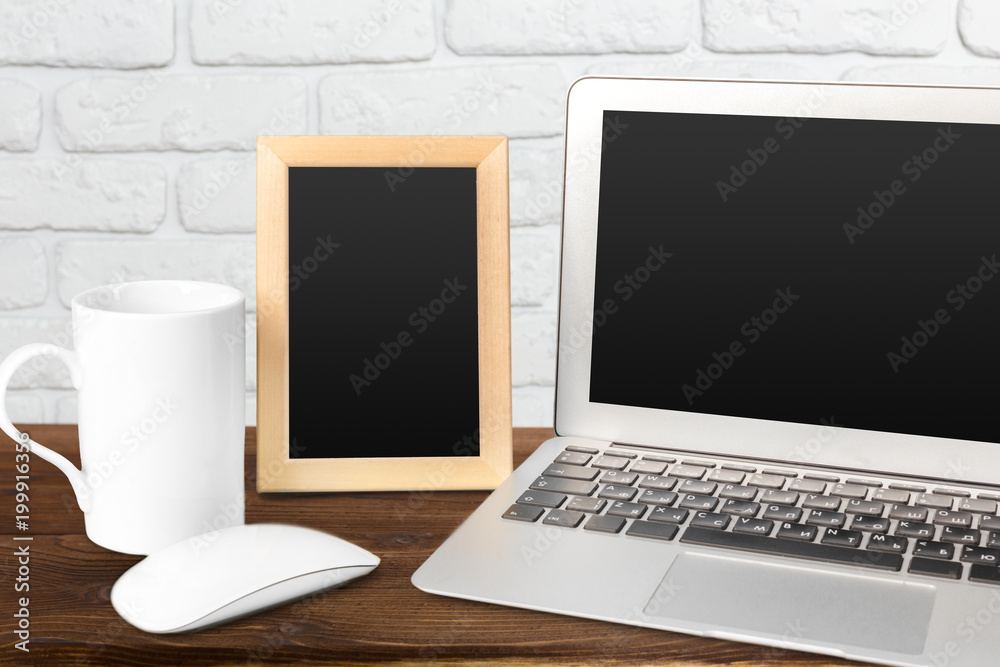 Fototapeta premium Laptop with blank screen on table