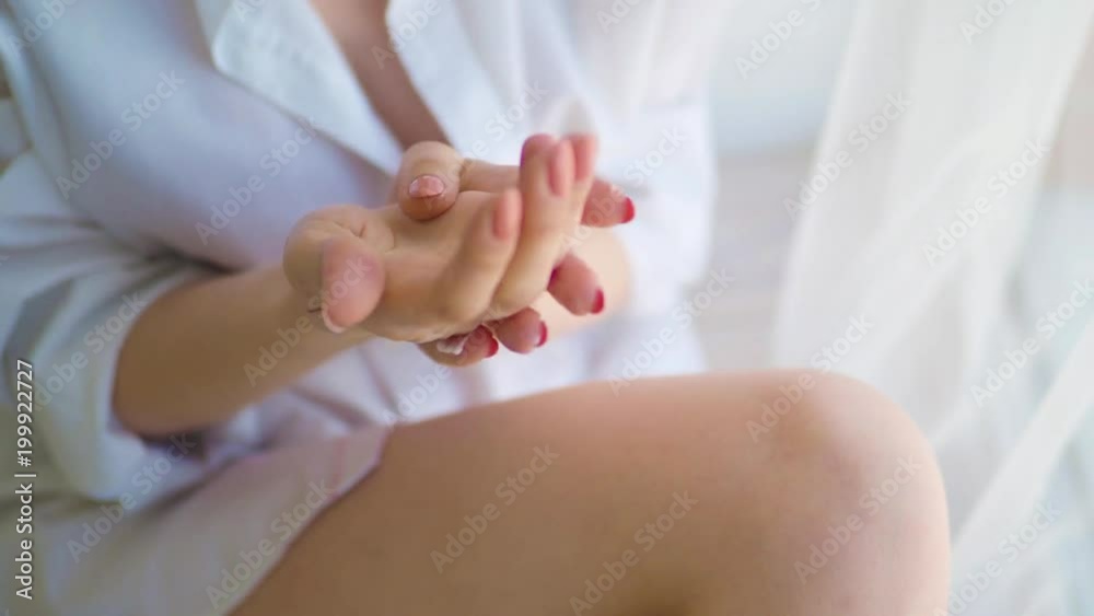 Beautiful Woman applying moisturizing cream on her Hands. Spa and Manicure concept. Female hands with french manicure. Soft skin, skincare concept. Beauty nails. Slow motion 4K UHD video. Beautiful Woman applying moisturizing cream on her Hands. Spa and Manicure concept. Female hands with french manicure. Soft skin, skincare concept. Beauty nails. Slow motion 4K UHD video.