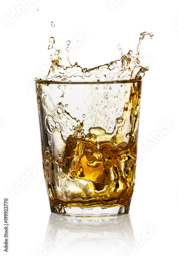 Splash in a transparent glass of whiskey
