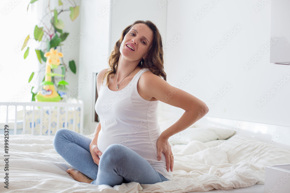 Young beautiful pregnant woman, in pain with labor contraction Young beautiful pregnant woman, in pain with labor contraction