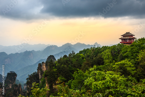 Pagoda on the hill with mountains in the background and forest in the foreground,  Zhangjiajie national park, Hunan province, China