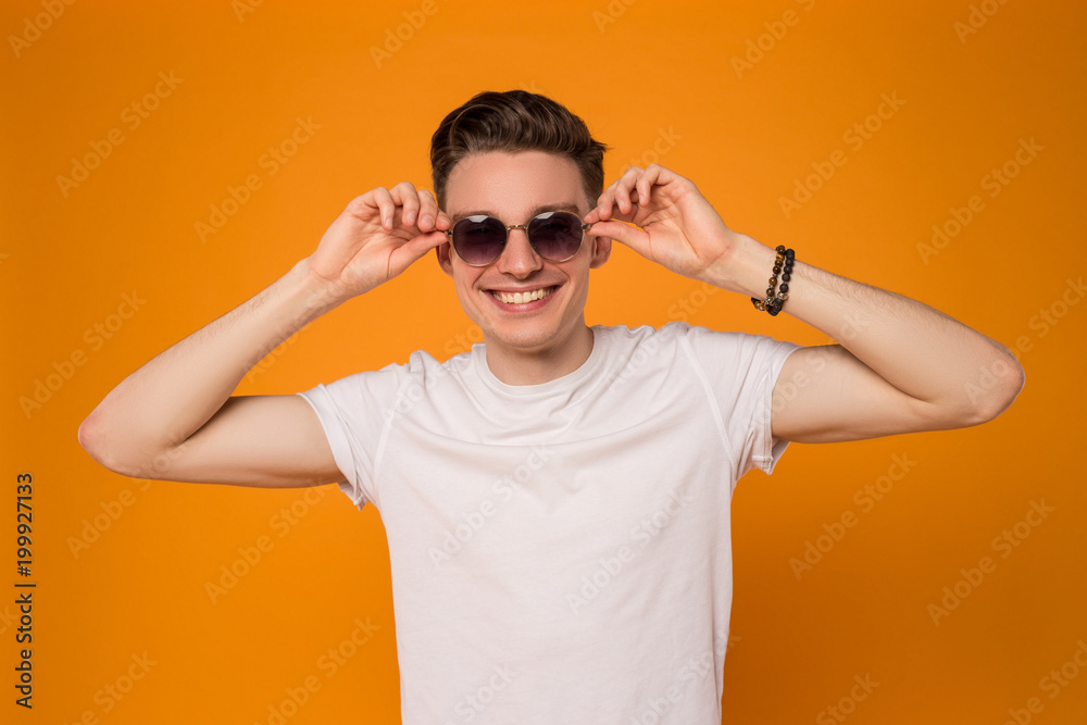 Live in the sunshine! Close up picture of the smiling good-looking boy being full of energy and happiness during summer. Live in the sunshine! Close up picture of the smiling good-looking boy being full of energy and happiness during summer.