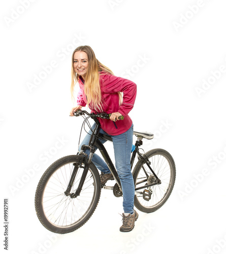 Girl in jeans on a bicycle on a white background.