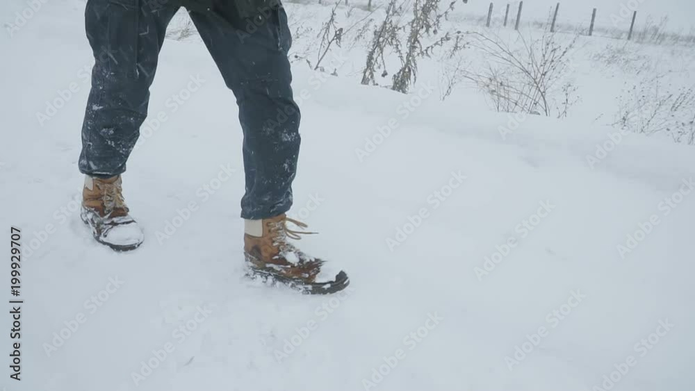 custom made wallpaper toronto digitalYoung man with backpack walking through a snowstorm in the snowy wilderness, struggling wind and extreme cold. Slow motion people footage.