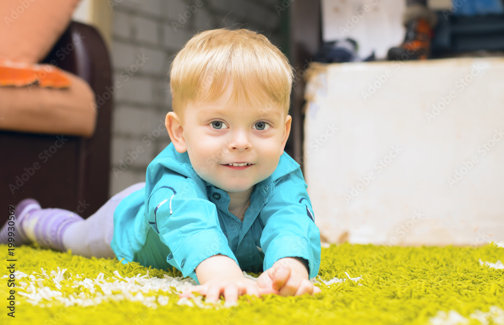 Fototapeta premium Boy lying on the floor