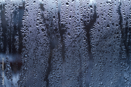 Rain drops on window glasses surface with sky cloudy background or texture grey frames abstract water of rainy day on black and white city at night silhouette Natural Pattern