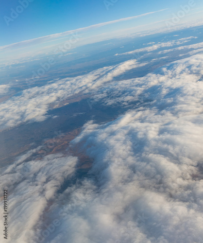 Aerial view of the Madrid region  outside the metropolitan area. Flying over agricultural fields and clouds.