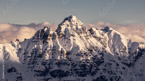 Scenic view of snowcapped mountain against cloudy sky