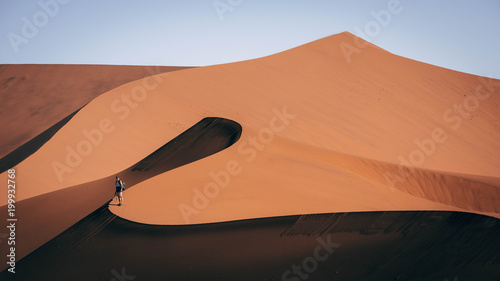 Hiker on sand dune photo