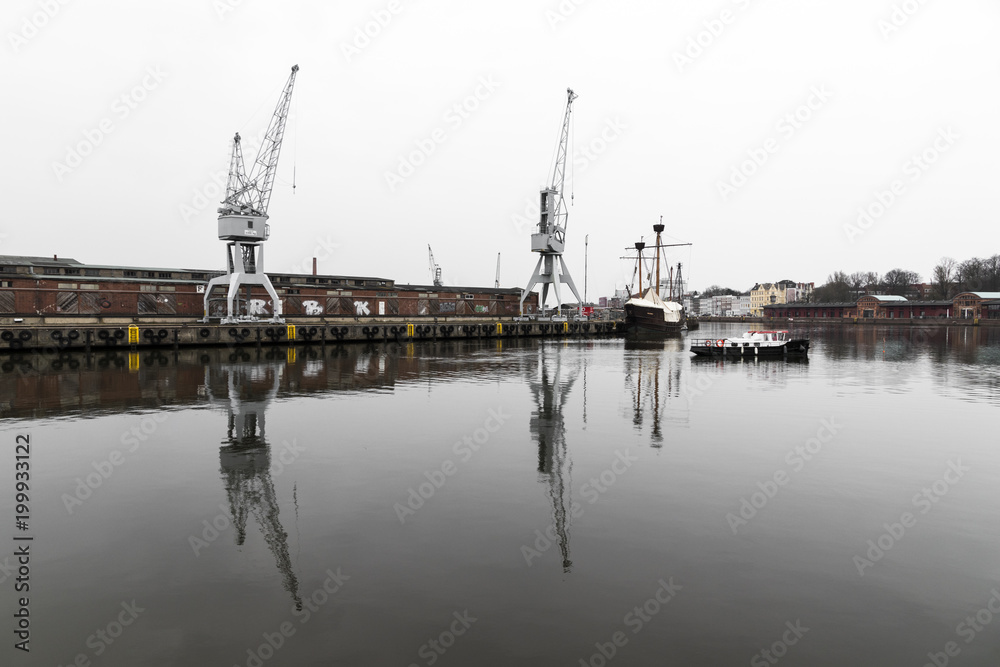 Lubeck, Germany. Boat and cranes at the harbor in the river Trave in Lubeck