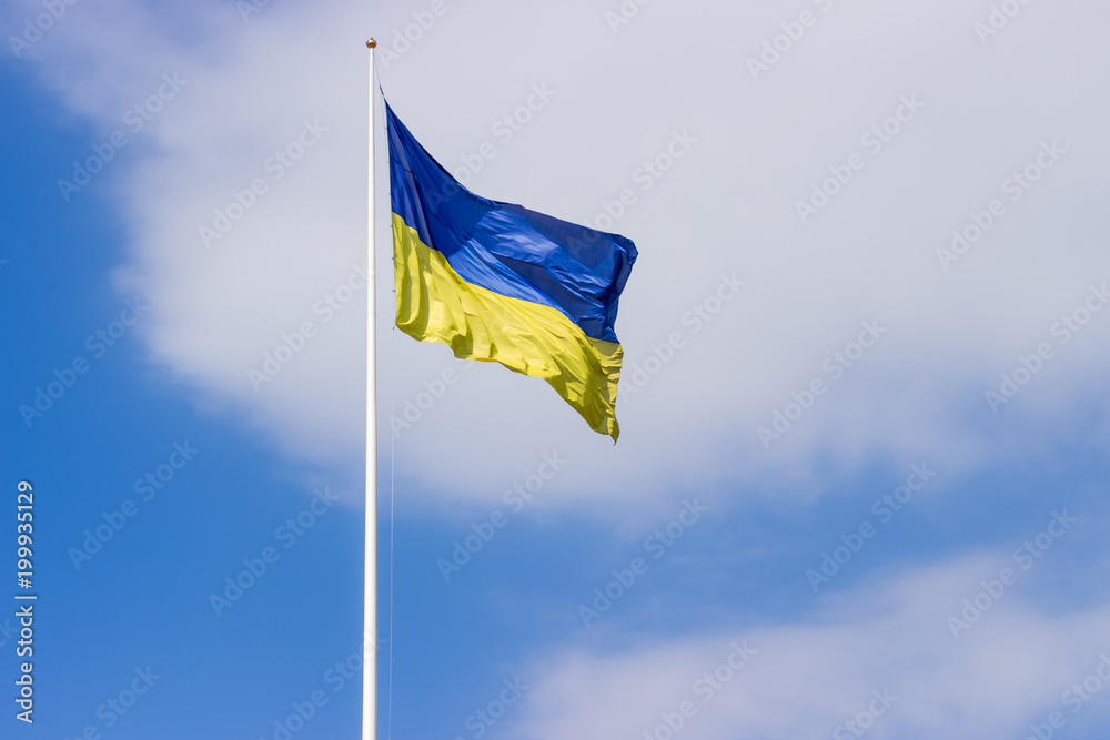 Ukrainian flag flying in the wind against of a sky Ukrainian flag flying in the wind against of a sky