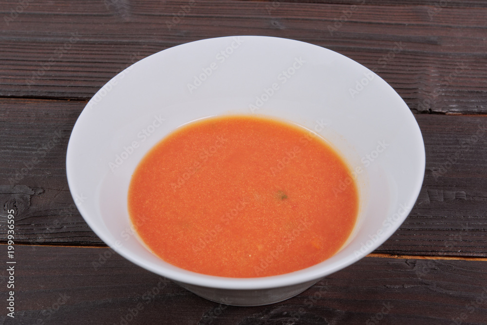 Tomato soup with milk on a table Tomato soup with milk on a table