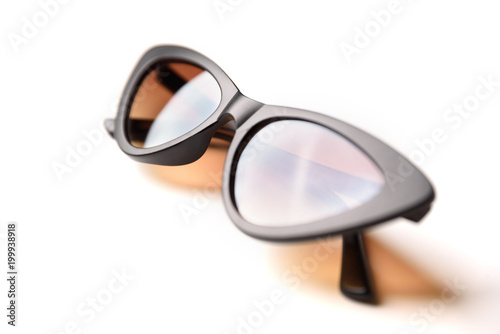 Black sunglasses with brown glasses close-up isolated on white background