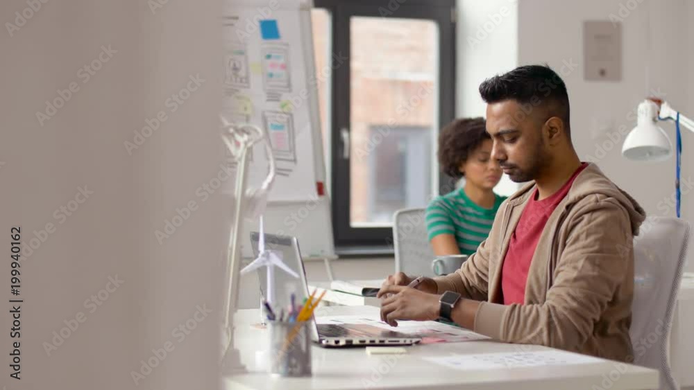 business and creative people concept - young indian man with laptop computer working at office business and creative people concept - young indian man with laptop computer working at office