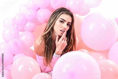 Happy smiling woman with long hair and colorful balloon celebrate party. Preparation to birthday party. Celebration concept. Girl with long hair and colorful balloon look at camera. Pink balloons.