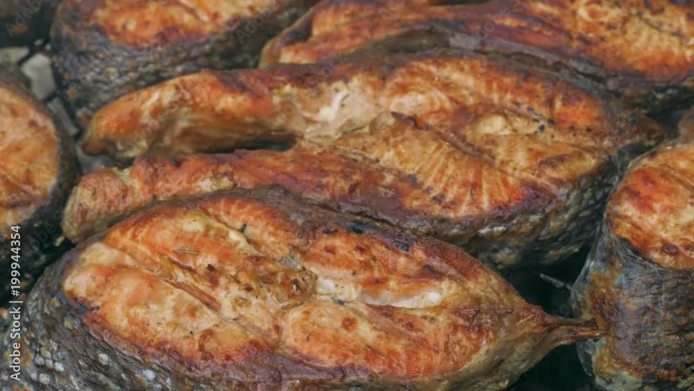 Fried grilled salmon on bbq. Marinade from white sauce and lemon. Trout fish. Fried grilled salmon on bbq. Marinade from white sauce and lemon. Trout fish.