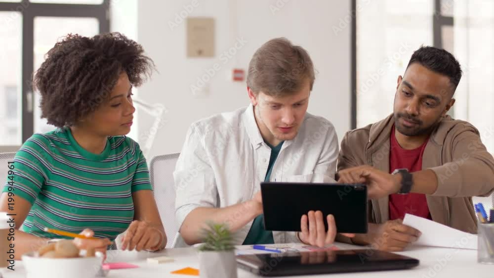 business, technology and people concept - happy creative team with tablet pc computer working at office business, technology and people concept - happy creative team with tablet pc computer working at office
