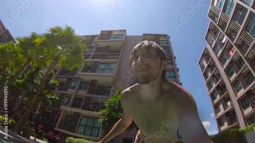 8x times slowmotion shot of a man jumping into pool photo