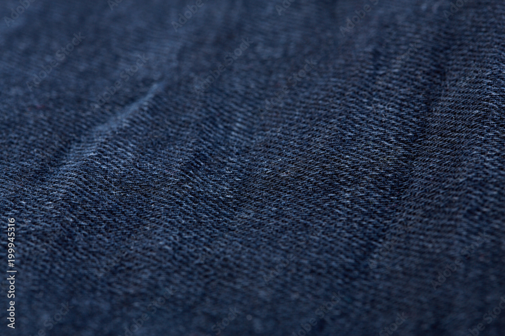 Denim jeans texture background with torn. The texture of the colored cotton fabric. Stitched texture jeans background. Fashion jeans button. Pocket and rivet on jeans. Fiber and fabric structure.