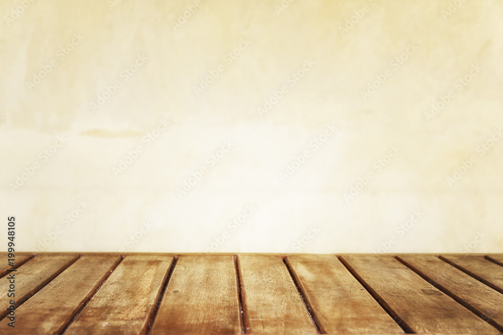 Brown wooden plank table against bright yellow wall blurred in background. Bright summer mock up, empty product display. Text space Brown wooden plank table against bright yellow wall blurred in background. Bright summer mock up, empty product display. Text space
