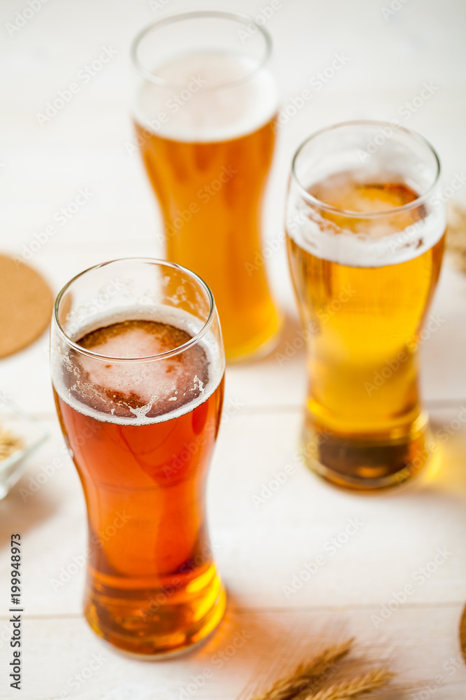 glasses of assorted beer with wheat on a wooden table background for tasting glasses of assorted beer with wheat on a wooden table background for tasting