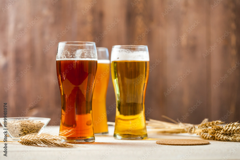 glasses of assorted beer with wheat on a wooden table background for tasting glasses of assorted beer with wheat on a wooden table background for tasting
