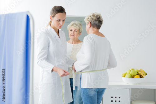 Dietician taking measurements of patient