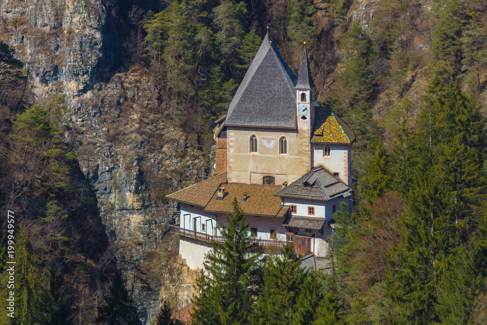 Picturesque view on the Sanctuary of San Romedio that is located on a steep rocky spur in the natural scenery of the Val di Non, Trentino, Italy Picturesque view on the Sanctuary of San Romedio that is located on a steep rocky spur in the natural scenery of the Val di Non, Trentino, Italy