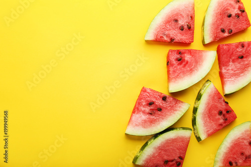 Slices of watermelons on yellow background