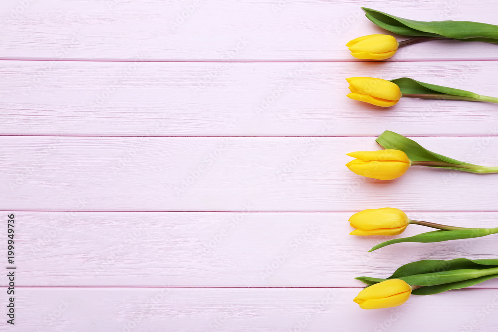 Bouquet of yellow tulips on pink wooden table Bouquet of yellow tulips on pink wooden table
